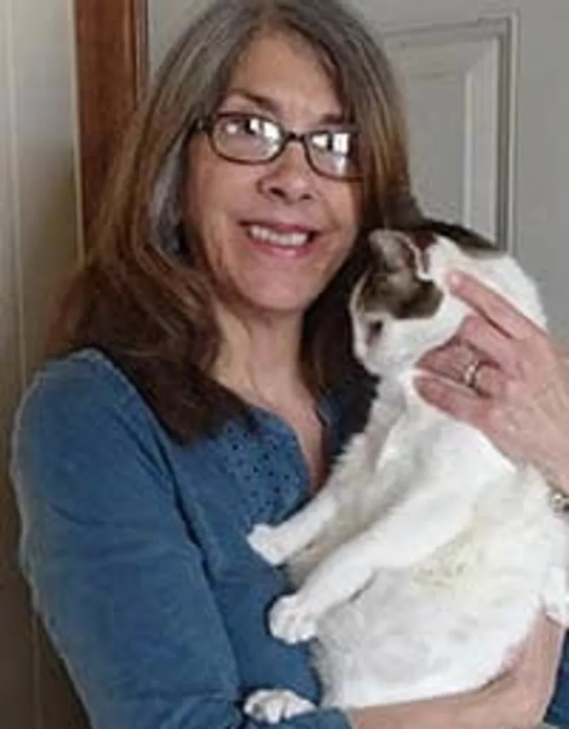 Christine Dobroth - Practice Manager holding a white cat